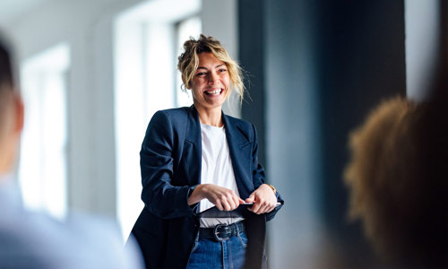 a woman smiling and holding a tablet